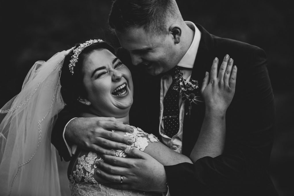 Bride laughing with groom
