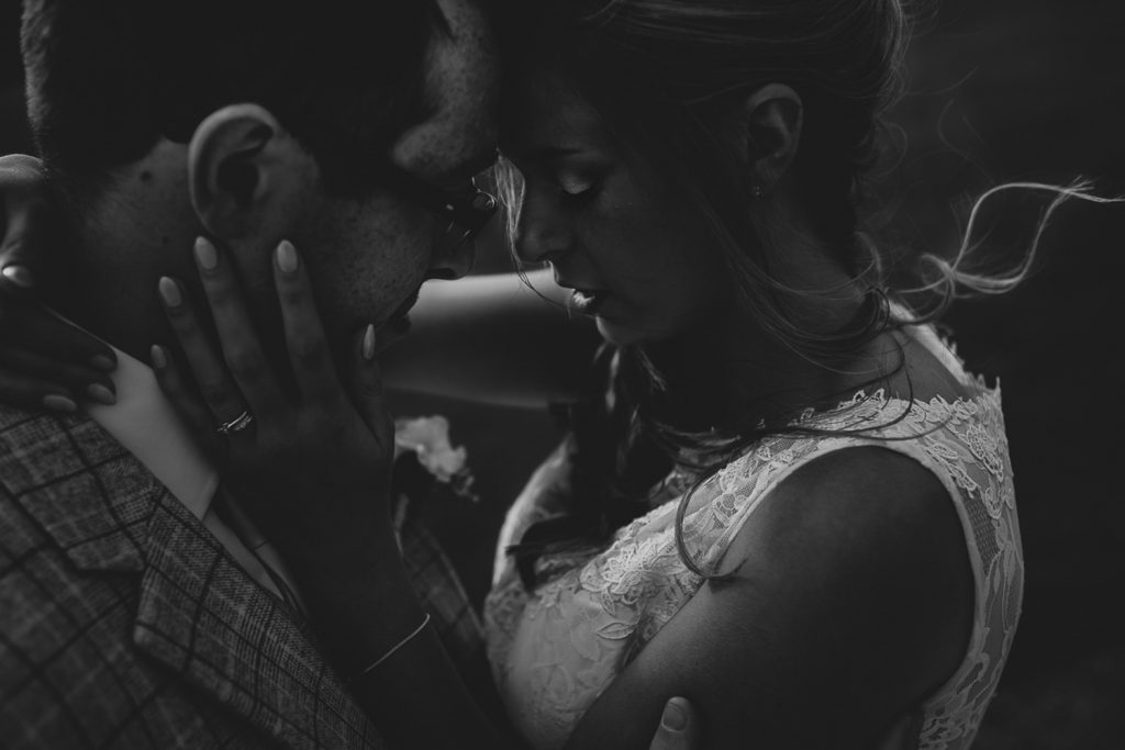 Black and white wedding couple hugging