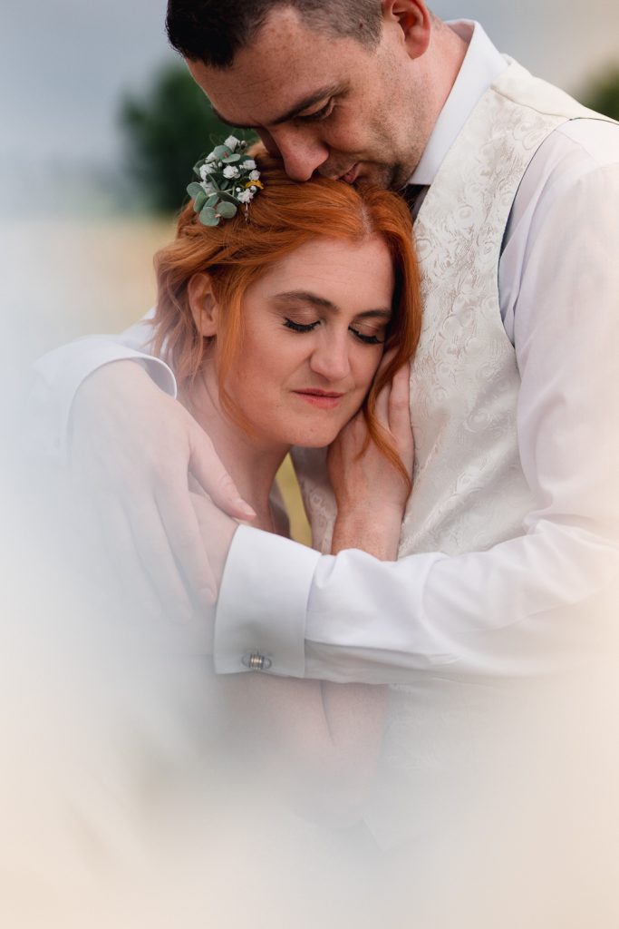 Bride and groom cuddling