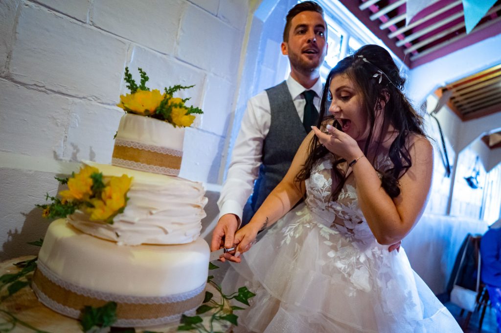 Couple cutting wedding cake