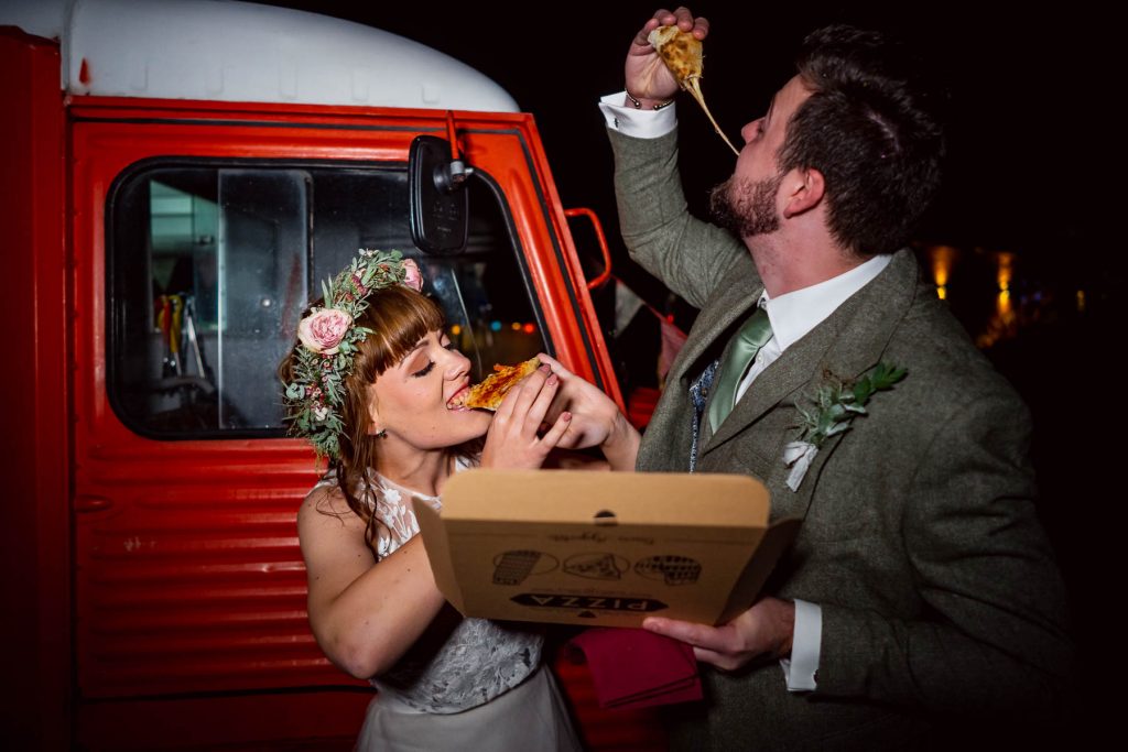 Bride and groom with pizza