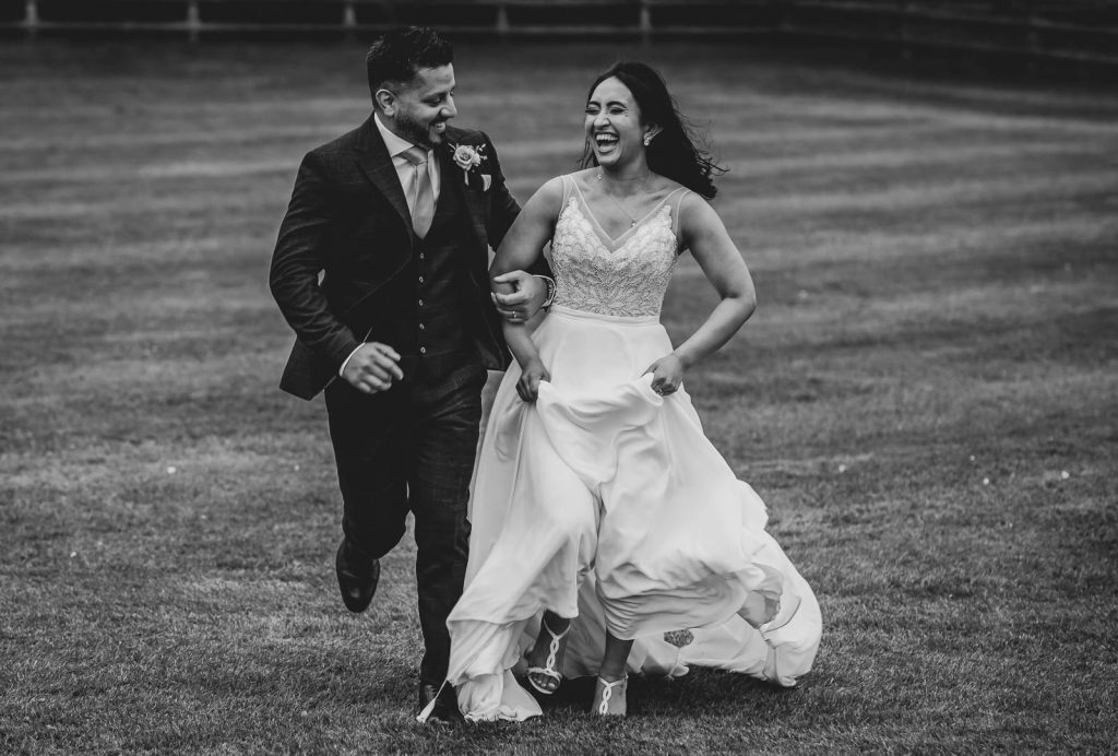 Couple running on wedding day