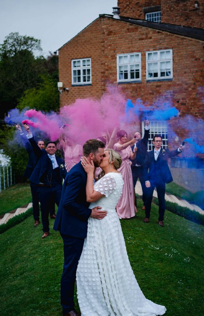 Bride and groom in smoke bombs