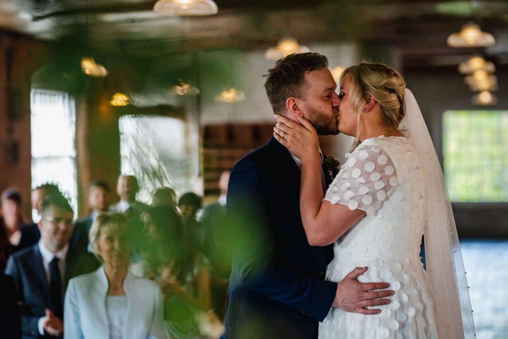 Bride and groom first kiss