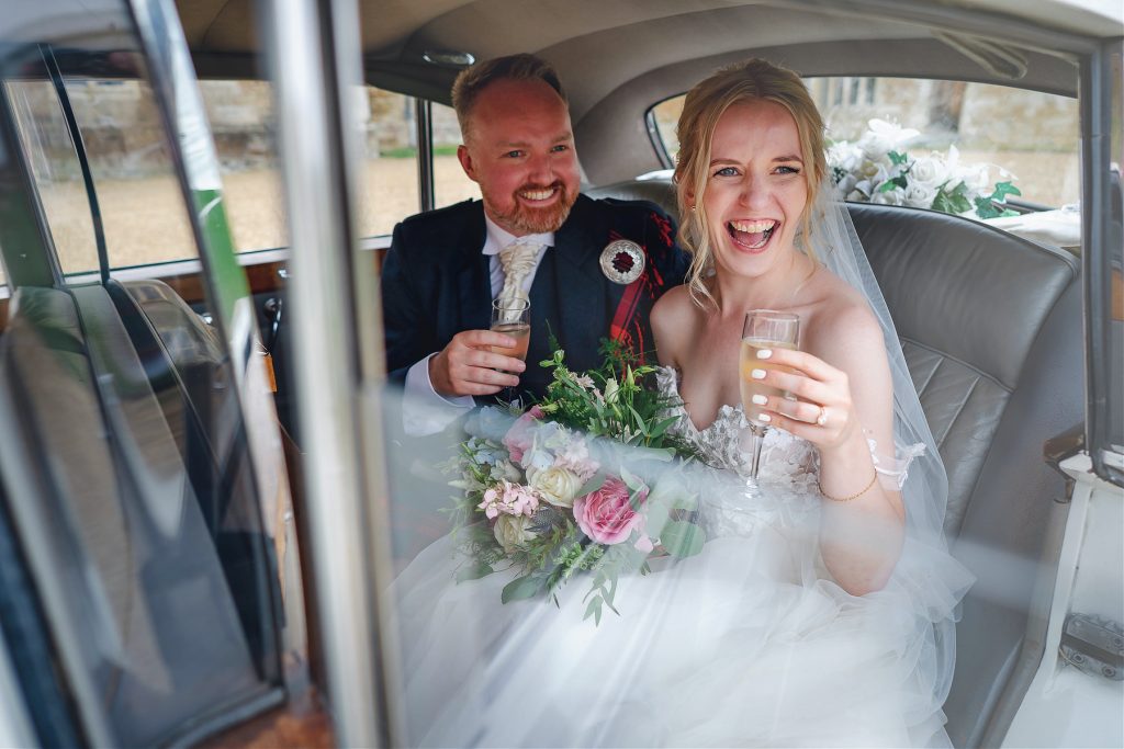 Bride and groom in car