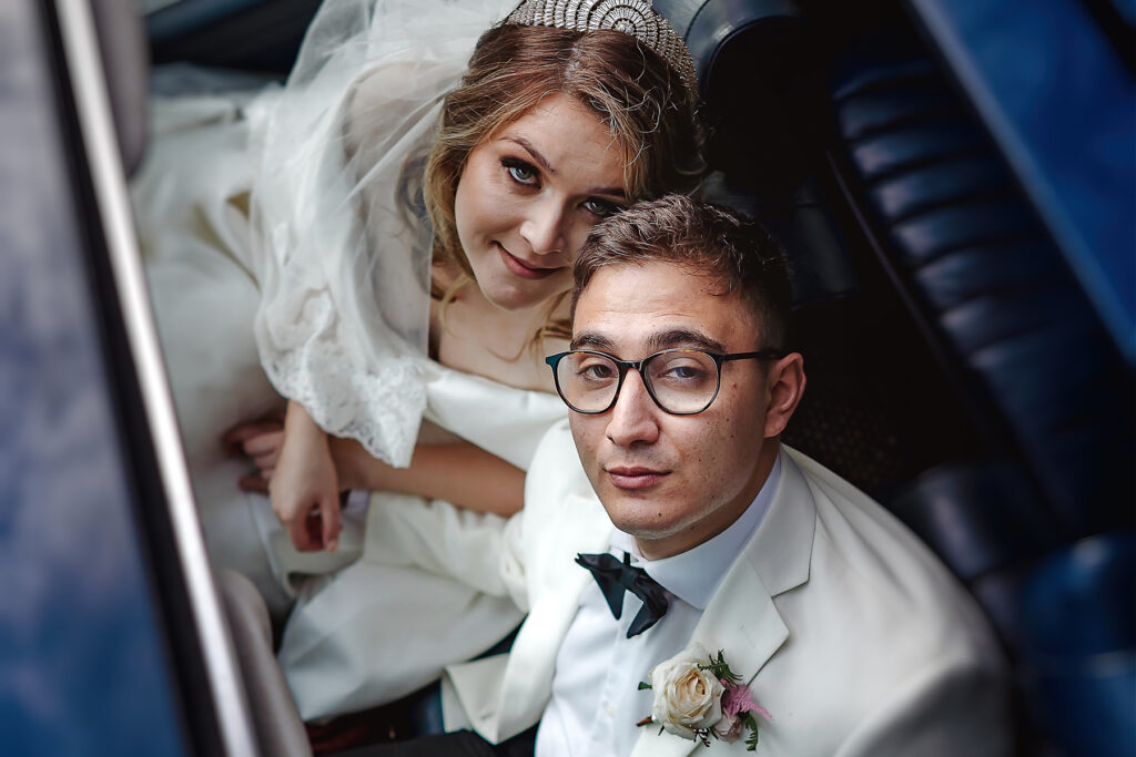 Bride and groom in car