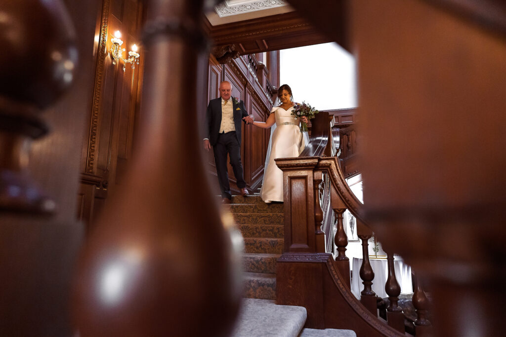 Dad walking bride down stairs