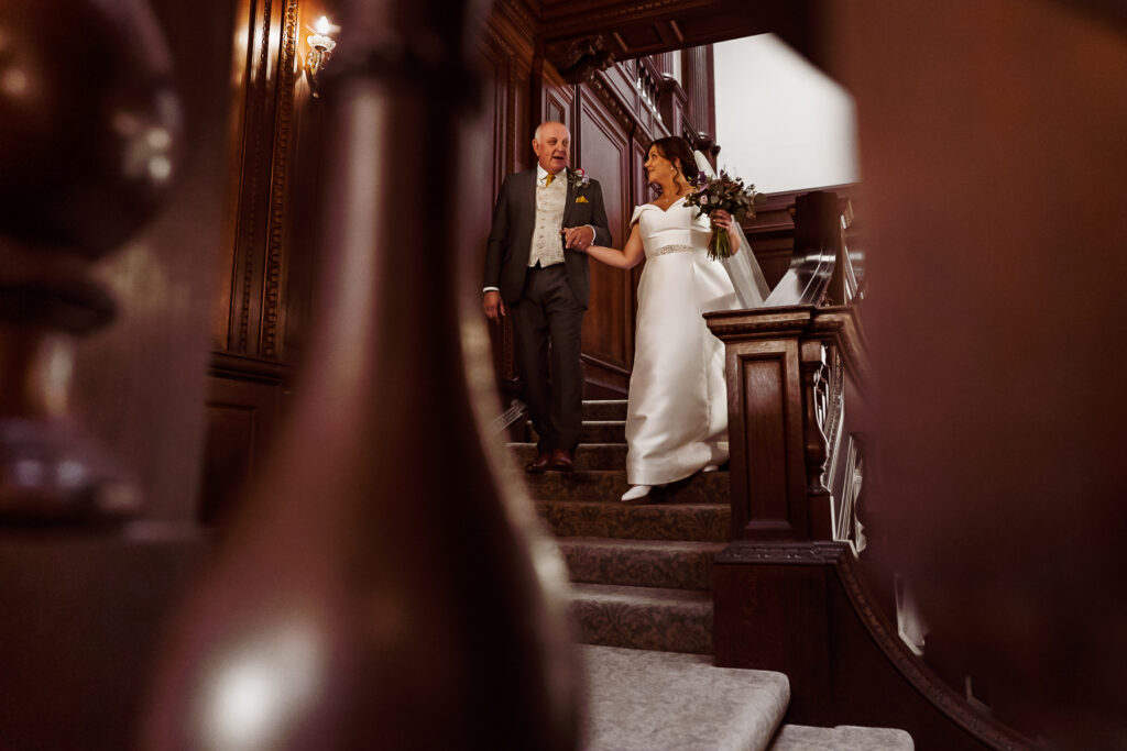 Dad walking bride down stairs