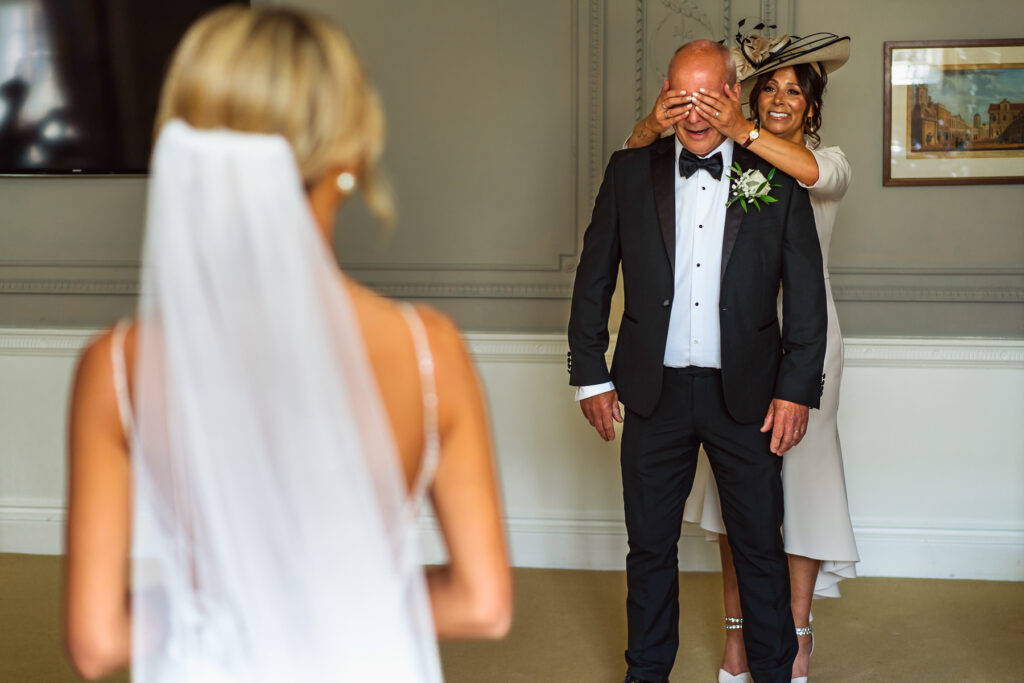 Bride getting ready with dad first look