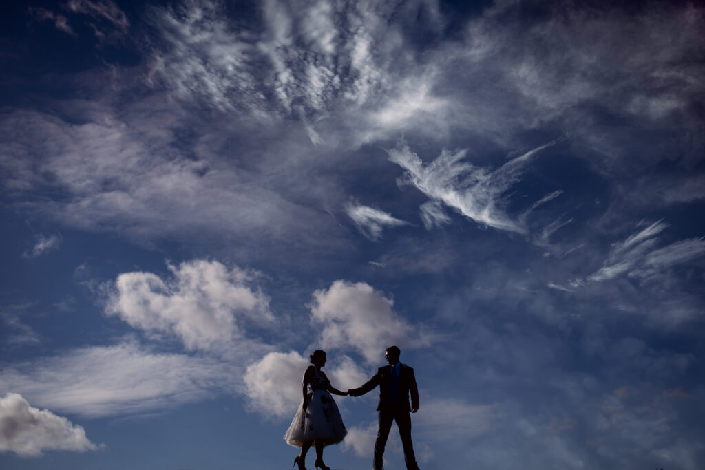 Wedding couple against stormy sky