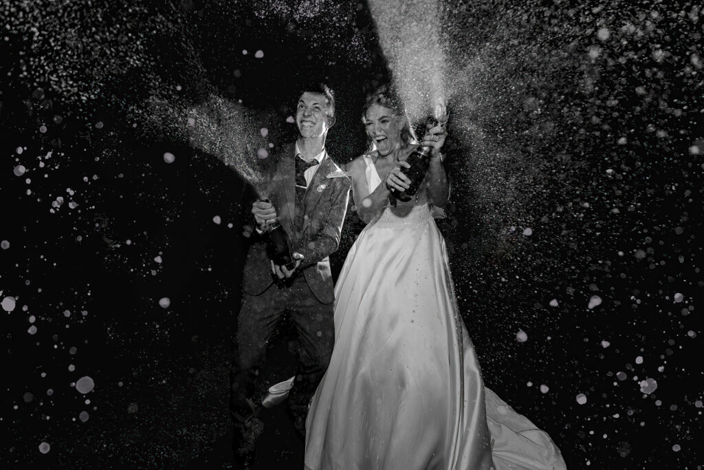 Couple doing champagne spray