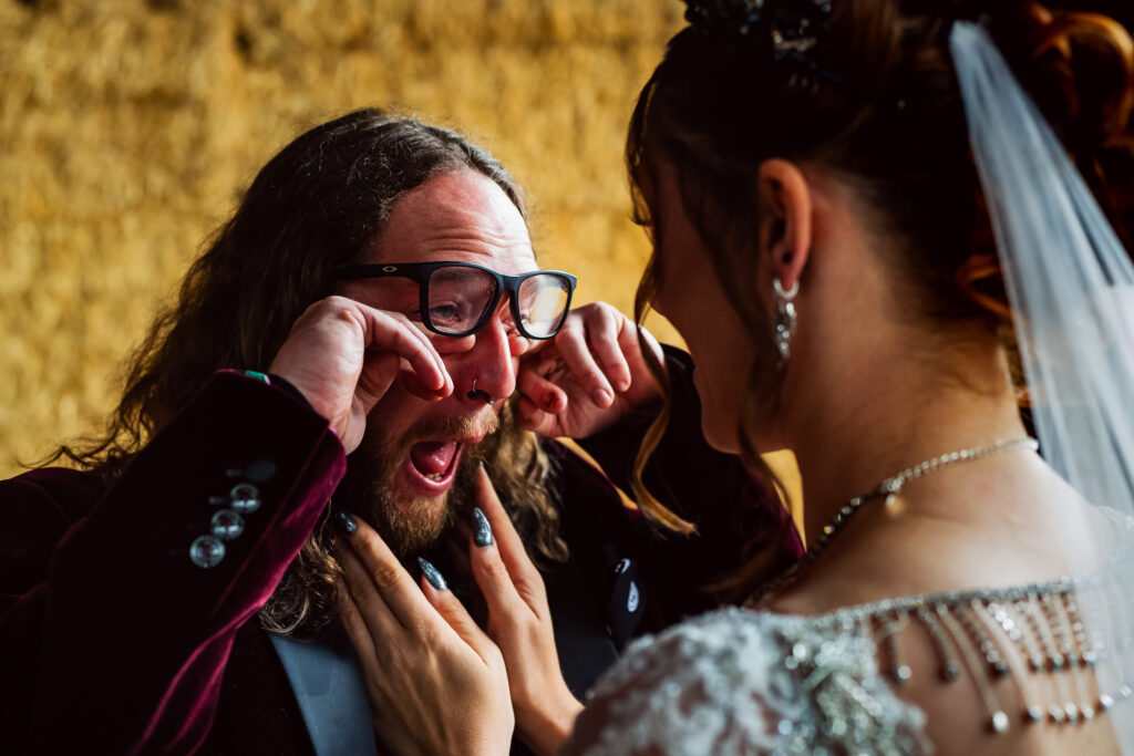 Groom crying with bride