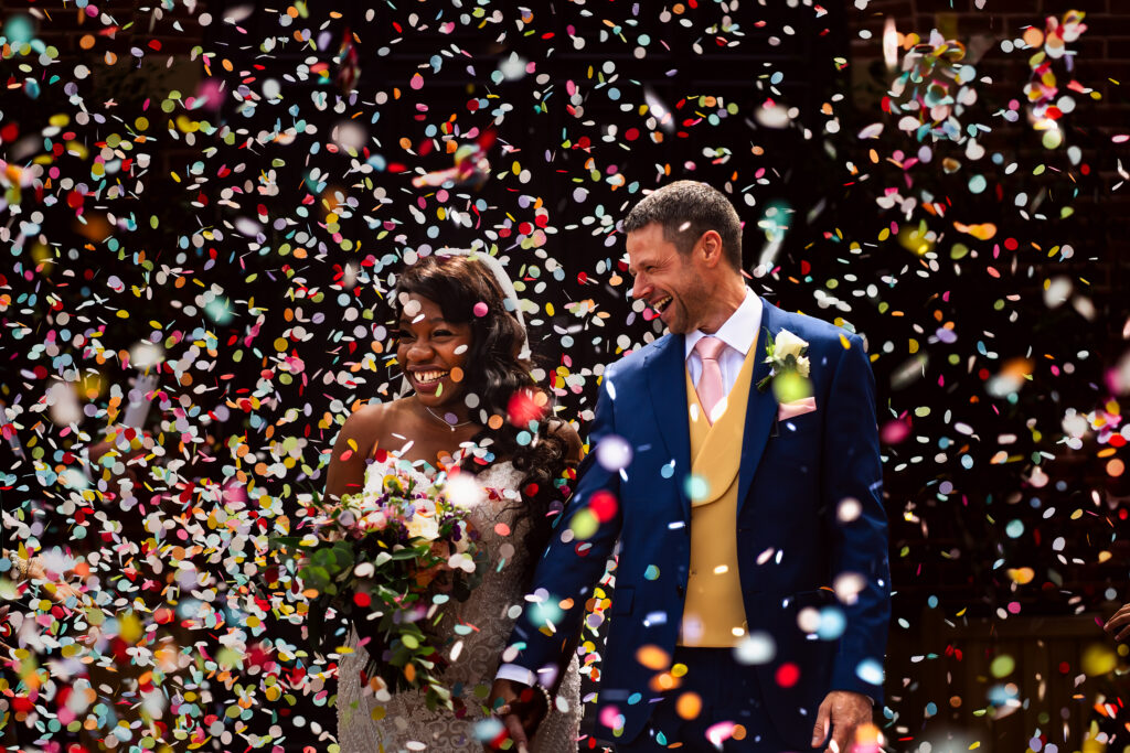 Birmingham wedding photographer with couple in confetti