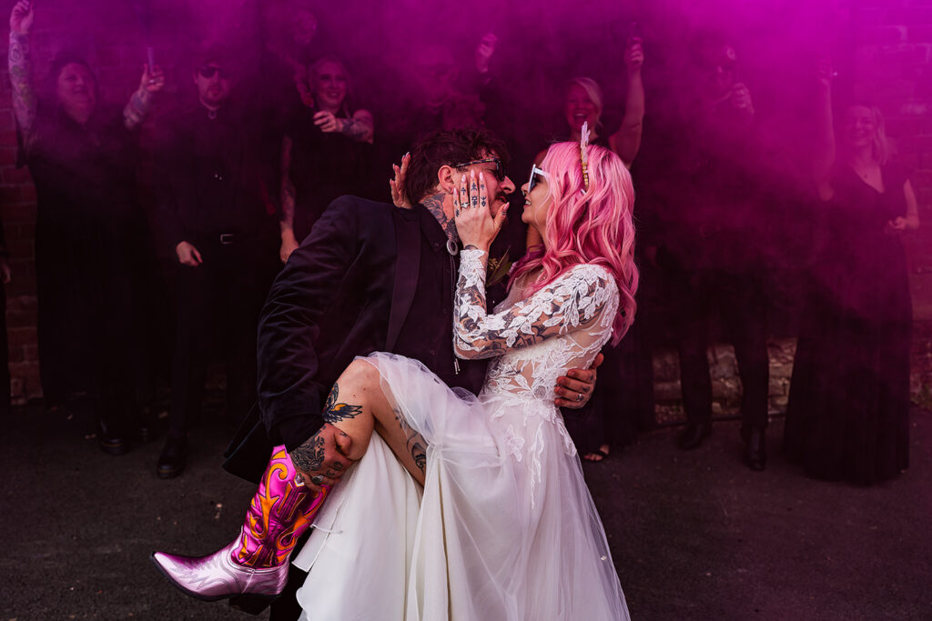 Wedding couple alternative in  pink smoke grenades