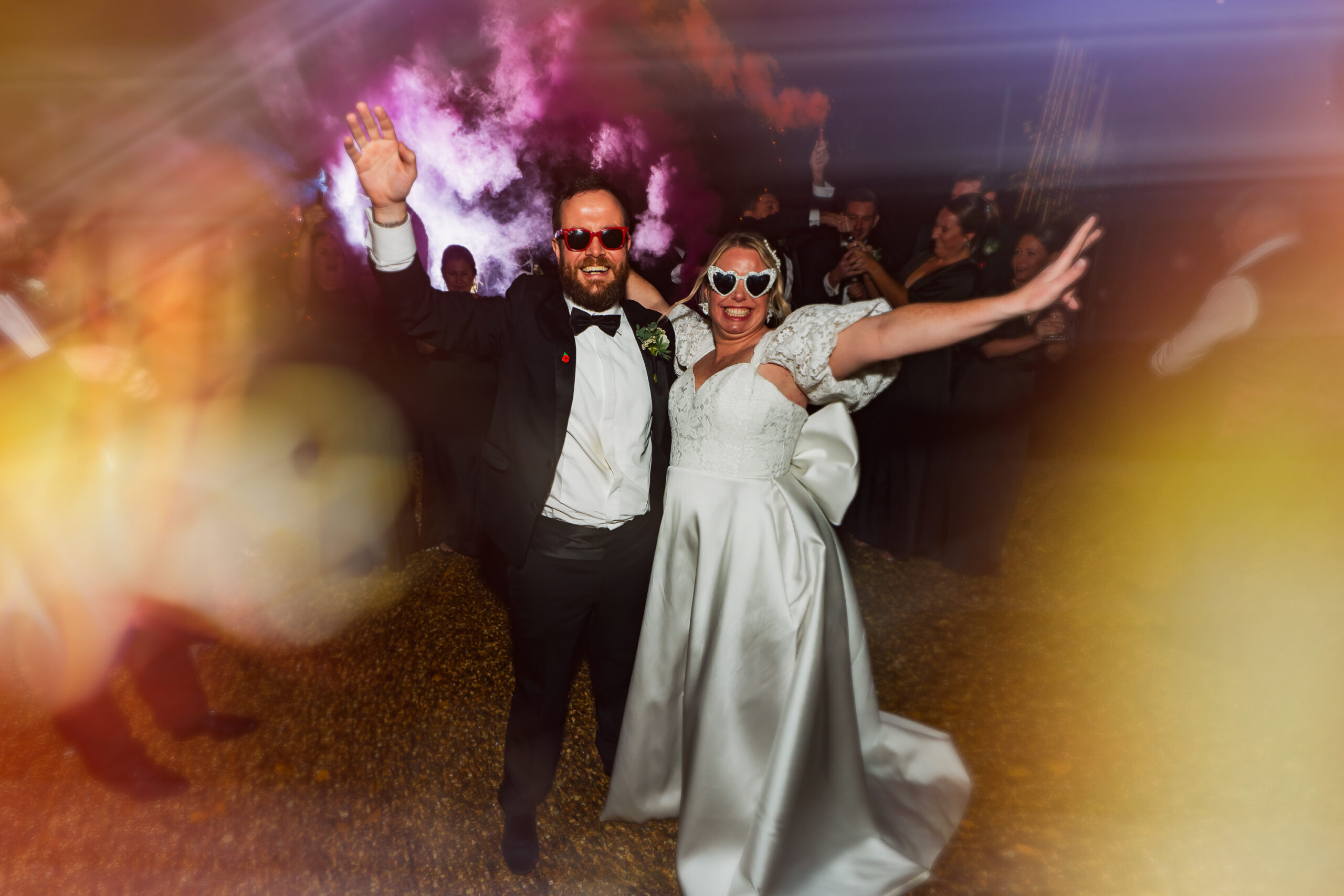 Couple with smoke bombs at night