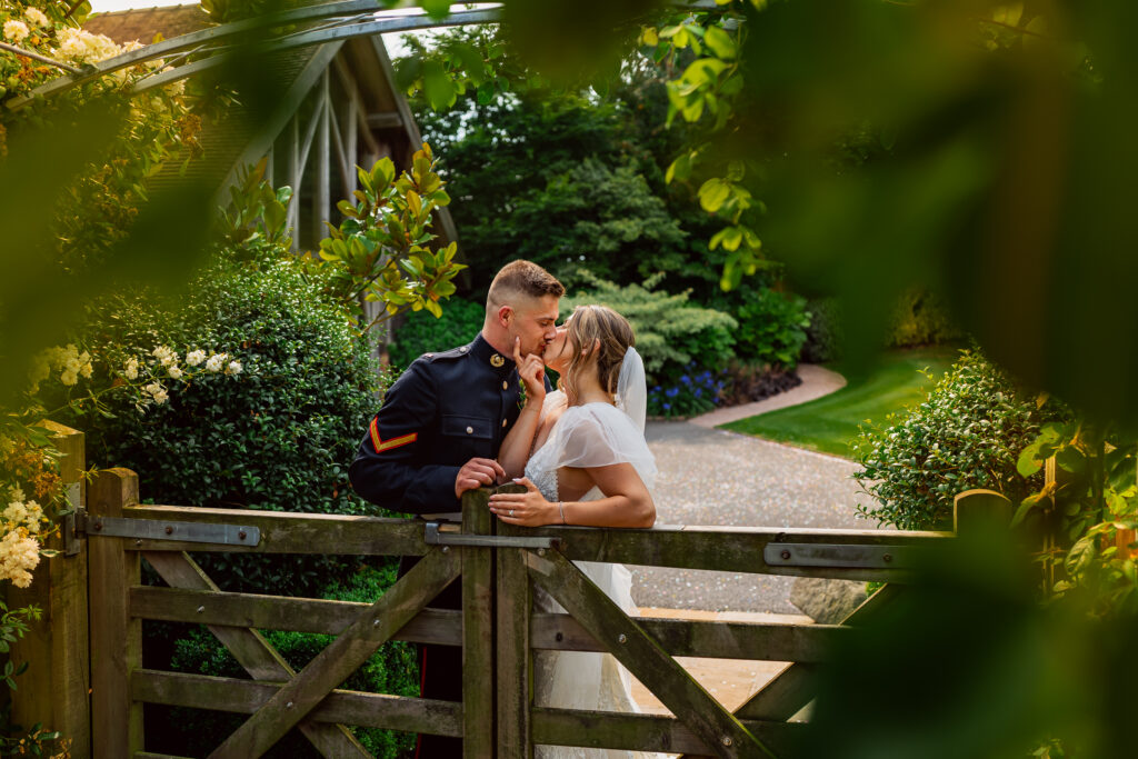 Wedding couple at Mythe Barn at gate