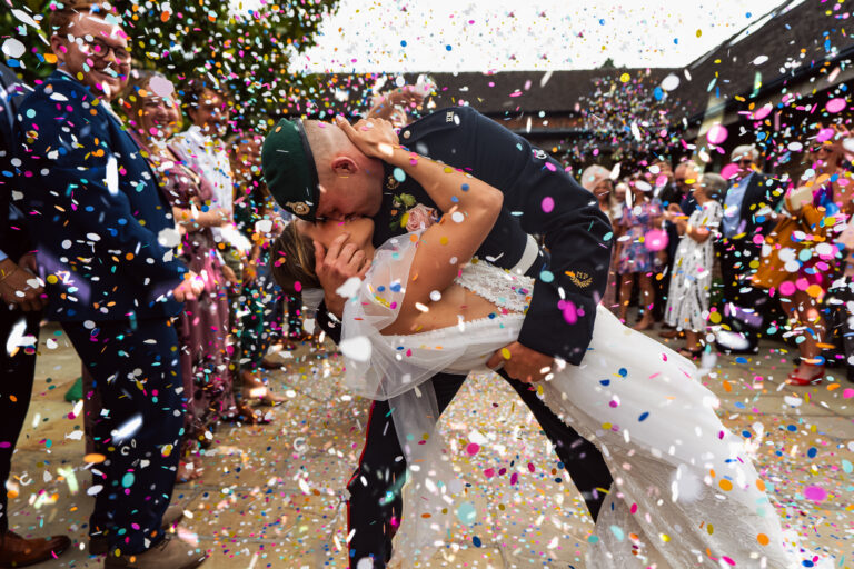 Wedding couple in confetti at Mythe Barn