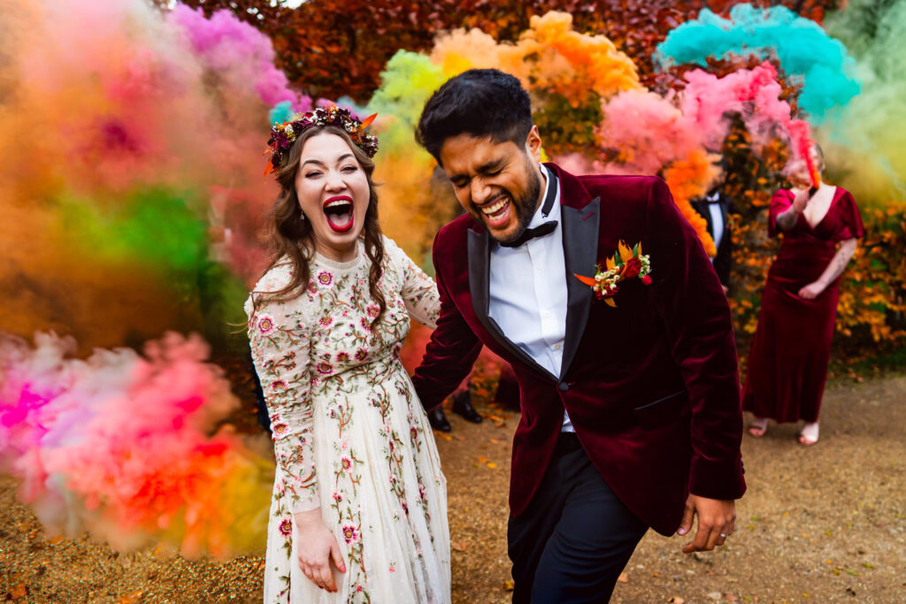 Wedding couple in front of colourful smoke