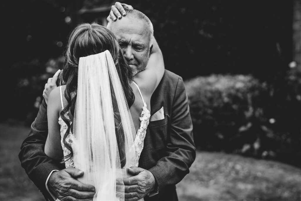 Birmingham wedding photography of bride hugging father